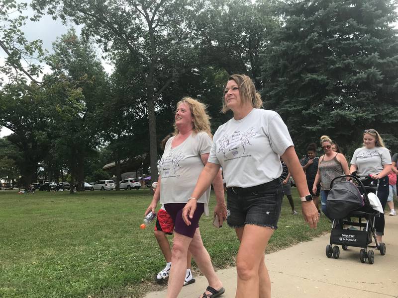 Dusty Roads founder Debbie Hallam (left) and Dare 2 Care founder Sherri Countryman lead the eighth annual Overdose Awareness Memorial Walk on Saturday morning from Streator City Park. Despite a less-than-ideal forecast, supporters largely filled the park by the 11 a.m. start time.