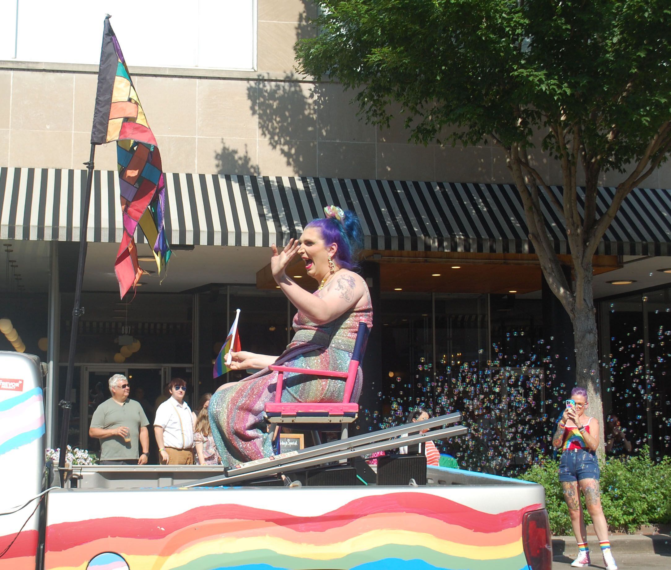 Mercury Stardust, also known as the Trans Handy Ma'am, waves to the crowd gathered along La Salle Street in downtown Ottawa for the John Fisher Dann Memorial Pride Parade. Mercury Stardust served as the parade grand marshal and was the VIP guest for the second annual Ottawa Family Pride Festival.