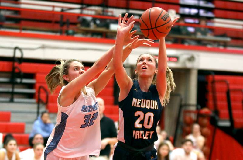 Nazareth’s Stella Sakalas (left) knocks the ball away from Neuqua Valley’s Kylee Norkus during a game at Hinsdale Central on Thursday, Nov. 16, 2023.