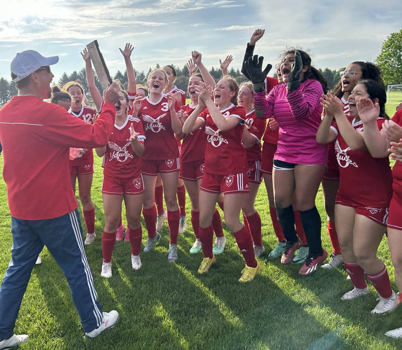 Oregon High School Athletic Director Mike Lawton presents the regional plaque to the Hawks' soccer team after the team won  the 1A Oregon Regional on Tuesday, May 14, 2024 downing Aurora Central Catholic 4-1 at Oregon Park East. With the win, the Hawks boosted their record to 18-1 and will face Stillman Valley at the Shabbona (Indian Creek) Sectional on Saturday, May 18.  Game time is noon.