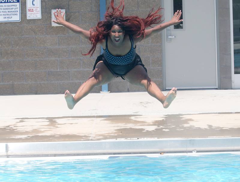 Bianca Brownfield leaps in the air while jumping into Riordan Swimming Pool on Monday, June 17, 2024 in Ottawa.