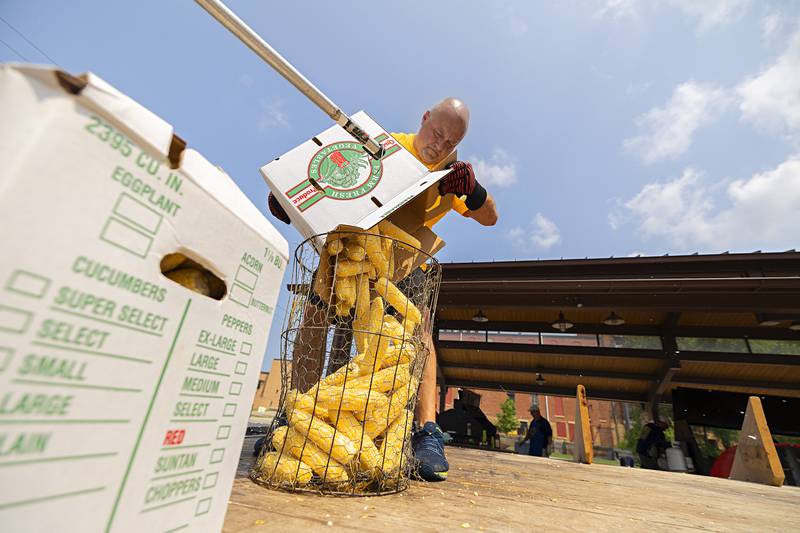 Dave Chavira readies another basket of sweet corn Monday, July 24, 2023 for the Rotary Corn Boil.