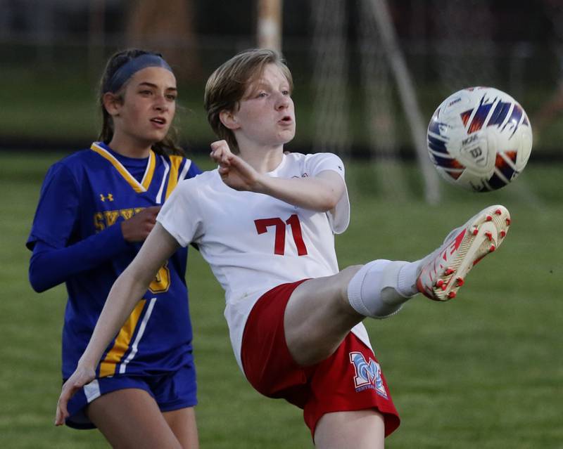 Marian Central'a Natalee Henkel kicks the ball away from Johnsburg's Charlie Eastland during the IHSA Class 1A Marengo Regional championship soccer match on Tuesday, May 14, 2024, at Marengo High School.