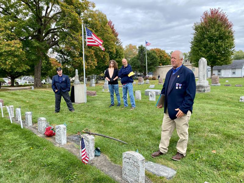 Dennis Maher (right), commander of the Brig. General E.F. Dutton Camp No. 49 and member of the Sons of the Union Veterans of the Civil War, gives an overview of the lives of several buried Sycamore Civil War veterans during the DeKalb County History Center’s annual Etched in Stone Cemetery Walk at Elmwood Cemetery, 901 S. Cross St., Sycamore on Sunday, Oct. 8, 2023.