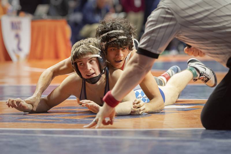 Marian Central’s Anthony Alanis controls Olympia’s Dylan Elmer in the 113 pound 1A third place match Saturday, Feb. 17, 2024 at the IHSA state wrestling finals at the State Farm Center in Champaign.