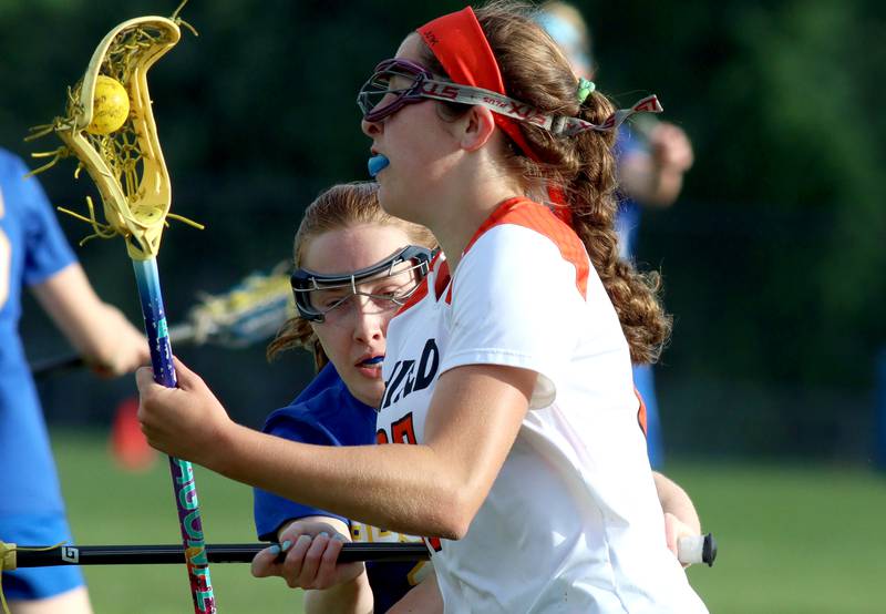 Crystal Lake Central’s Anna Starr, front, moves past Lake Forest’s Megan Rocklein during girls lacrosse supersectional action at Metcalf Field on the campus of Crystal Lake Central Tuesday.