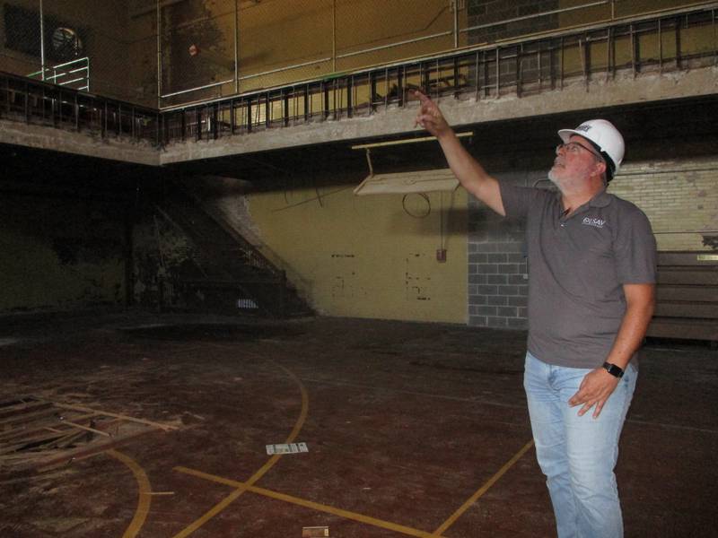 Peter Bohler, project manager with R. Berti Building Solutions, points to trusses that will be removed during the demolition of the old Joliet Catholic High School gym. Aug. 28, 2024