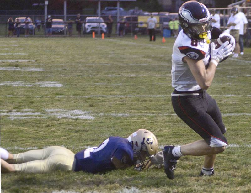 Aurora Christian’s Jonan Miceli breaks a table to score on a run in the 2nd quarter Friday at Marquette.