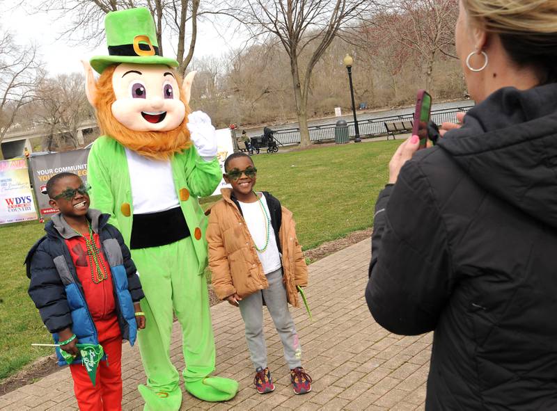 Eight-year-old Jaylin and his 7-year-old brother Josiah get their picture taken with a leprechaun by Grandma Deb Chatman after the Yorkville St. Patrick's Day parade on Hydraulic Avenue, Saturday, Mar. 16, 2024.