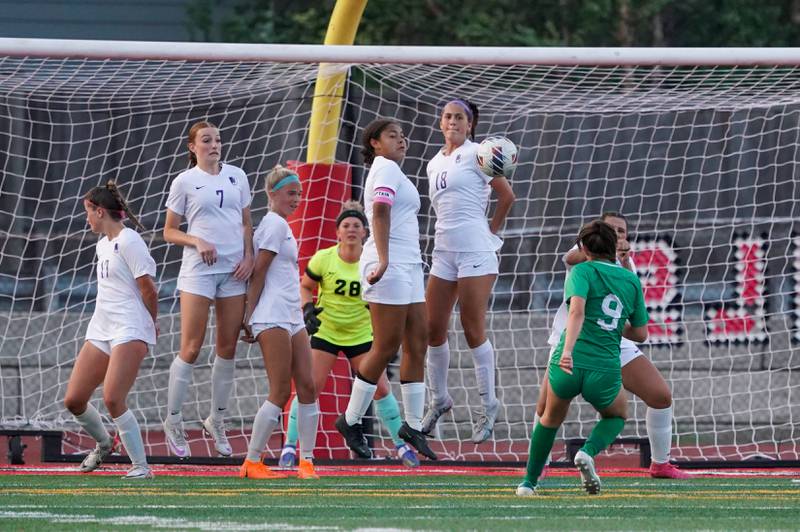 Downers Grove North players form a wall to defend against a free kick by York’s Sophia Musial (9) during a Class 3A Hinsdale Central Sectional semifinal soccer match at Hinsdale Central High School in Hinsdale on Tuesday, May 21, 2024.