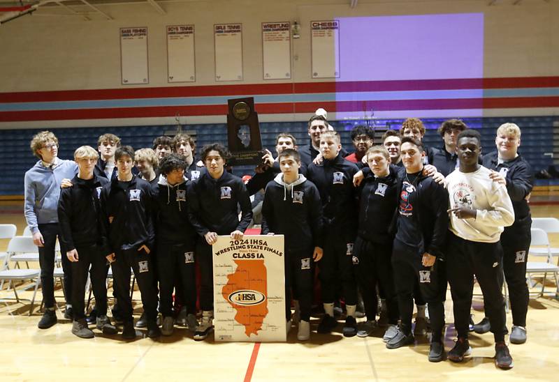 Marina Central wrestlers pose for a team photograph during a celebration on Friday, March 8, 2024, at theMarian Central High School in Woodstock.