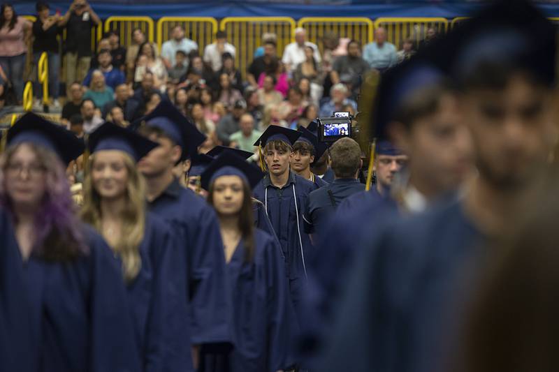 Graduating seniors file into the field house Friday, May 24, 2024 for commencement. The ceremony was moved indoors due to bad weather.