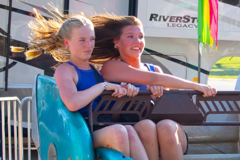 Girls ride the Sizzler on Friday, June 21, 2024 at the Ottawa Lions Club Carnival in Ottawa.