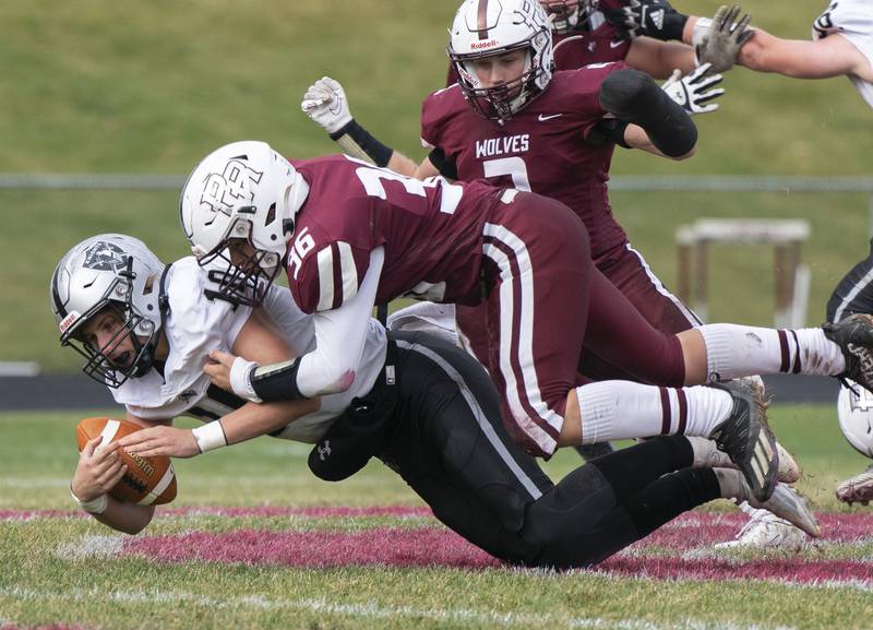 Prairie Ridge's Giovanni Creatore sacks Kaneland quarterback Troyer Carlson during the 6A second-round football playoff game on Saturday, November 5, 2022 at Prairie Ridge High School in Crystal Lake. Prairie Ridge won 57-22.