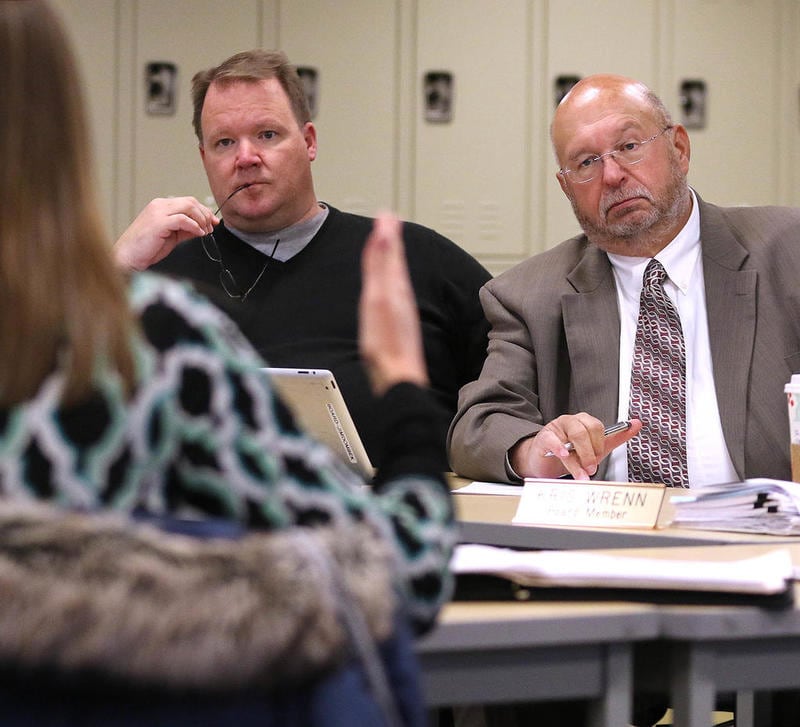 Sycamore School District 427 Board President  Jim Dombek (right) and board member Steve Nelson listen as Nicole Stuckert, District 427 chief financial officer, talks about the 2018 tax levy at a board meeting at Sycamore Middle School.