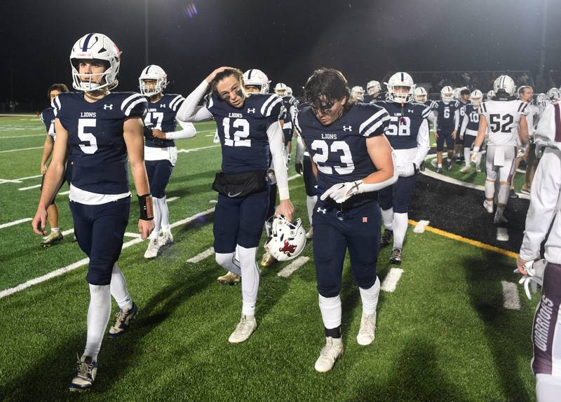 Joe Lewnard/jlewnard@dailyherald.com
St. Viator players including quarterback Cooper Kmet, left, walk toward the sideline after shaking hands with Wheaton Academy players at the conclusion of Friday’s Class 4A football playoff game in Arlington Heights Friday. Wheaton Academy won 12-3.