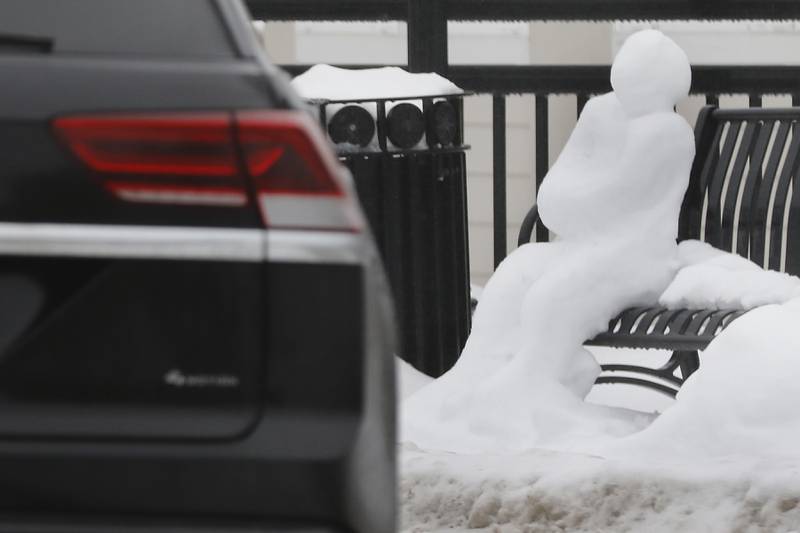 A snow person appears to watch traffic flow past them on Tuesday, Jan. 23, 2023, at the roundabout in Johnsburg. Residents throughout northern Illinois woke up to icy and slippery roads.