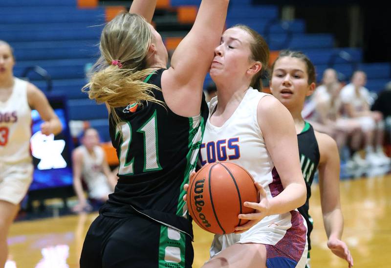 Genoa-Kingston's Ally Poegel gets hit in the face by Rock Falls' Nicolette Udell on the way to the basket during their game Friday, Feb. 2, 2024, at Genoa-Kingston High School.