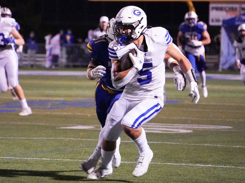 Geneva’s Dylan Reyes (5) runs after the catch against Wheaton North during a football game at Wheaton North High School on Friday, Oct. 6, 2023.