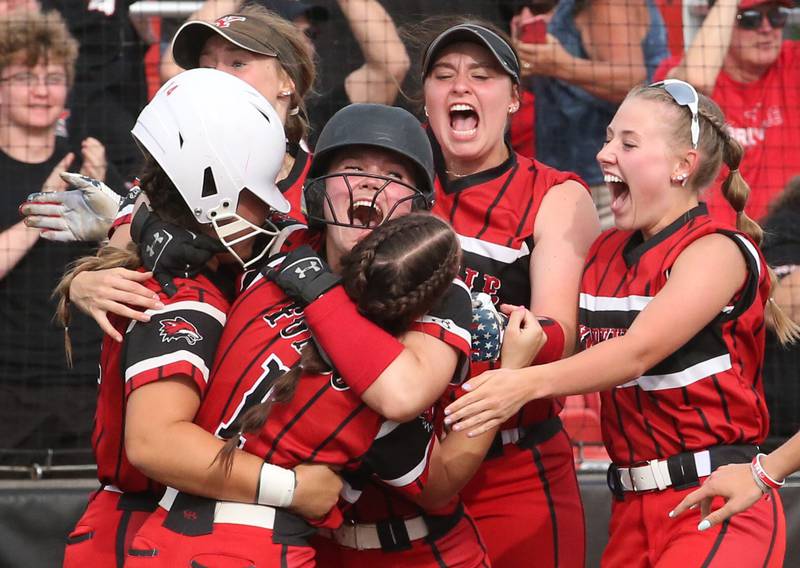 Members of the Yorkville softball team react behined hoome plate after defeating Oak Park-River Forest in thirteen innings during the Class 4A State semifinal softball game on Friday, June 9, 2023 at the Louisville Slugger Sports Complex in Peoria.