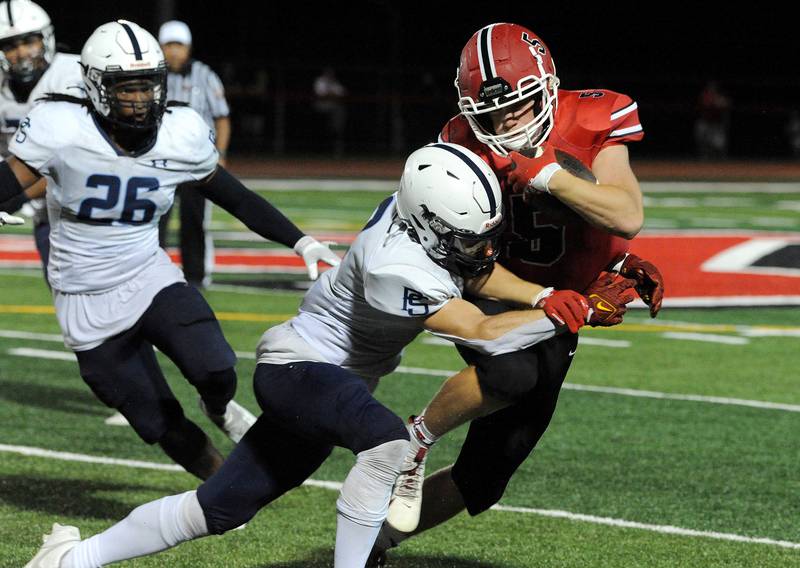 Yorkville running back Ryan Wulff (5) manages to shed a Plainfield South tackle on Friday, Sep. 30, 2024, at Yorkville High School.