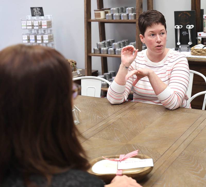 Joni Peterson, owner of 35:35 Makers Collective, talks Friday, March 18, 2022, to local artisans who will have their work available for purchase in the shop. The store, at 308 West State Street in Sycamore, is scheduled to open April 1.