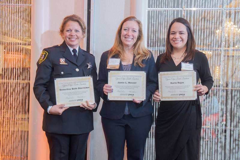 Detective Beth Sterricker (left), State's Attorney Jamie Mosser and Karla Rojas stand together with awards they received at the YWCA Elgin Leader Luncheon held on May 9 at The Seville in Streamwood.