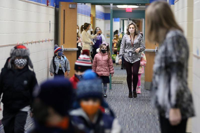Students head to their classes during the first day back to hybrid learning in Huntley Community School District 158, incorporating a split between remote and in-person learning, on Monday, Jan. 25, 2021, at Leggee Elementary School in Huntley.