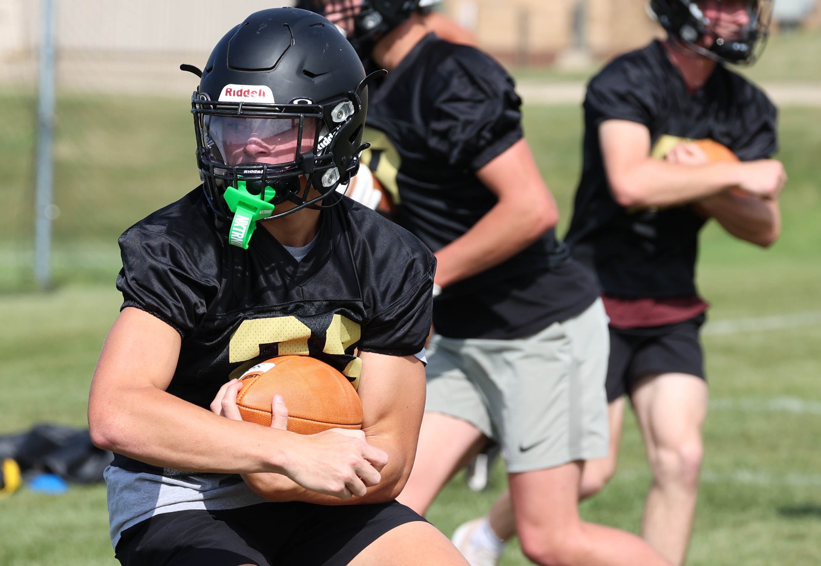 Sycamore’s Dylan Hodges carries the ball in a drill Monday, Aug. 12, 2024, during the first practice of the regular season.