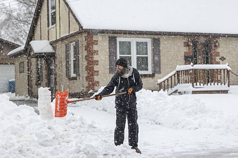 Dustin Jones shovels his Dixon driveway on Friday, Jan. 12, 2024 as the area gets hit hard with snow.