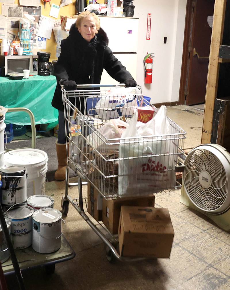 Stage Coach Players Outreach Committee member Jan Kuntz wheels a cart full of donated food items into the theater in DeKalb Tuesday, Nov. 15, 2022, for their Thanksgiving food drive. The group is working with the Salvation Army to put together Thanksgiving meals for local families in need.