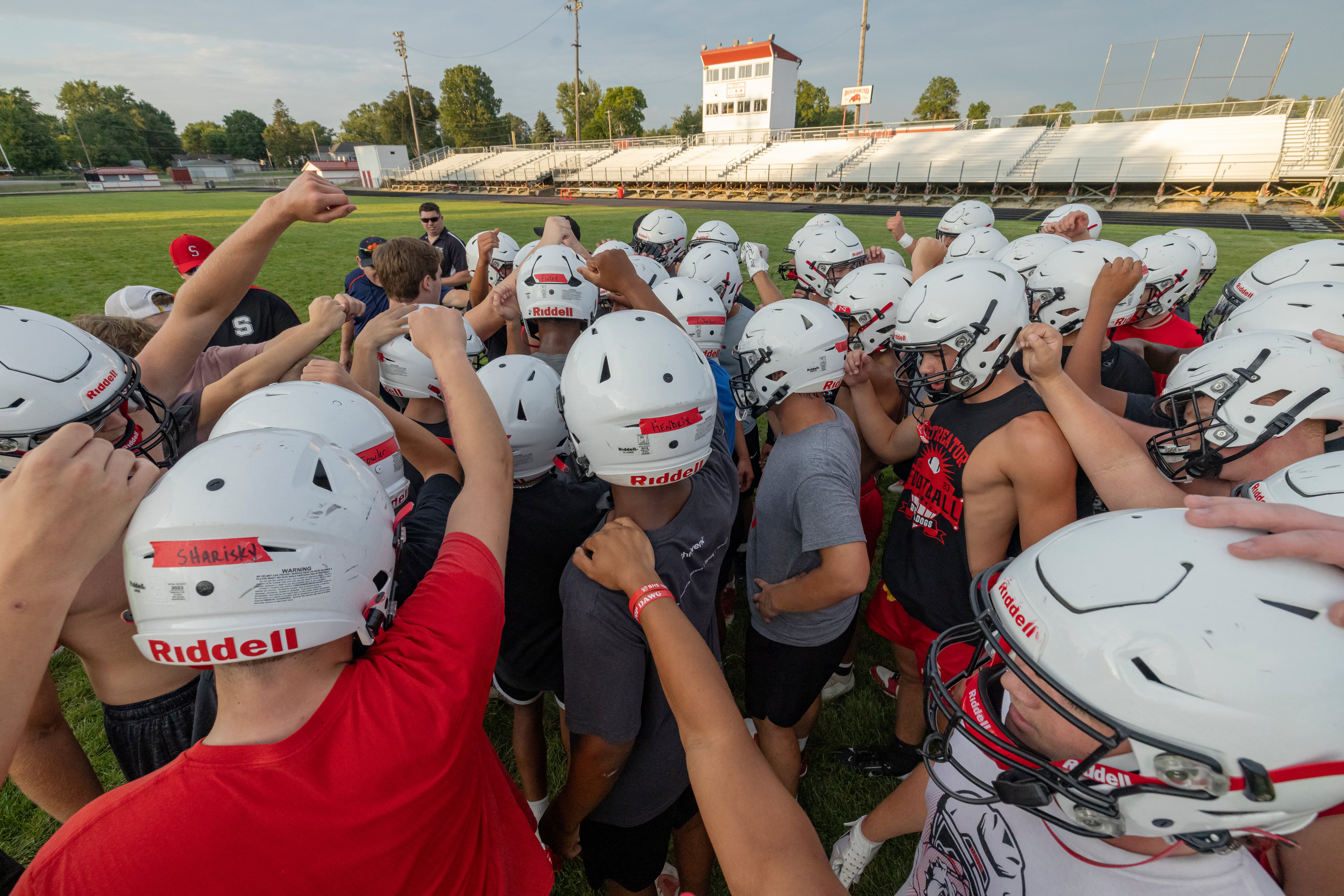 The Streator Bulldogs football team brings in the huddle at the end of opening practice day at at Doug Dieken Stadium on August 12, 2024.