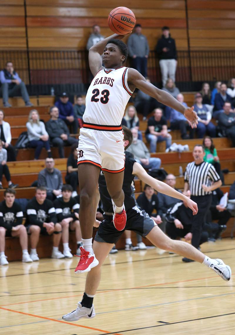 DeKalb’s Davon Grant goes in for a dunk in front of Kaneland's Bradley Franck during their game Monday, Feb. 12, 2024, at Huntley Middle School in DeKalb.