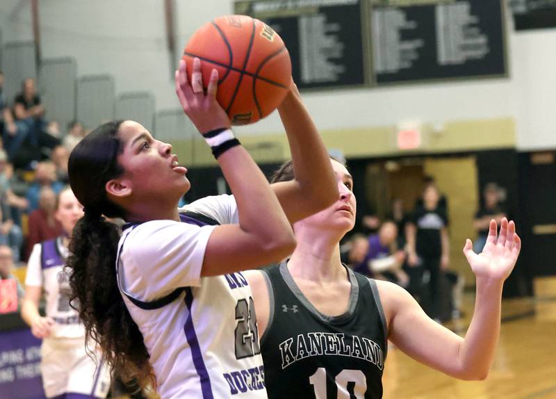 Dixon’s Ahmyrie McGowan goes to the basket against Kaneland's Emily Kunzer Thursday, Feb. 22, 2024, during their Class 3A sectional final game at Sycamore High School.