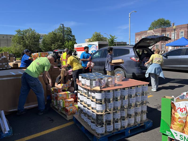 Volunteers participate in a free food giveaway event on Saturday, May 25, outside the Will County office building, 302 N. Chicago St., Joliet. The event was hosted by Will County Executive Jennifer Bertino-Tarrant and nonprofit organization ShareFest Will County.