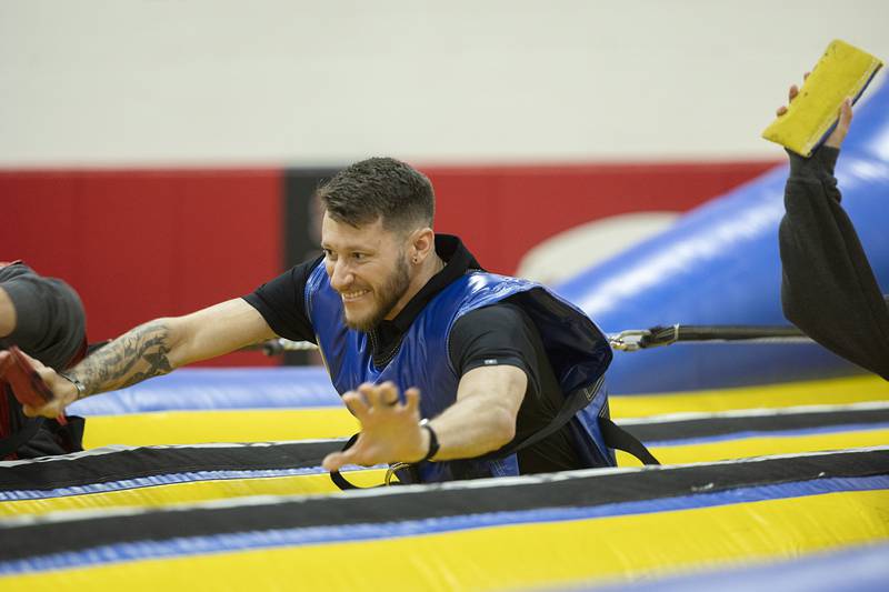 SVCC police academy student Devin Teske of Rock Falls  fights against a bungee cord Wednesday, Jan. 31, 2024, at Sauk Fest at Sauk Valley Community College. The school brought in a number of fun inflatables as a welcome back to students.