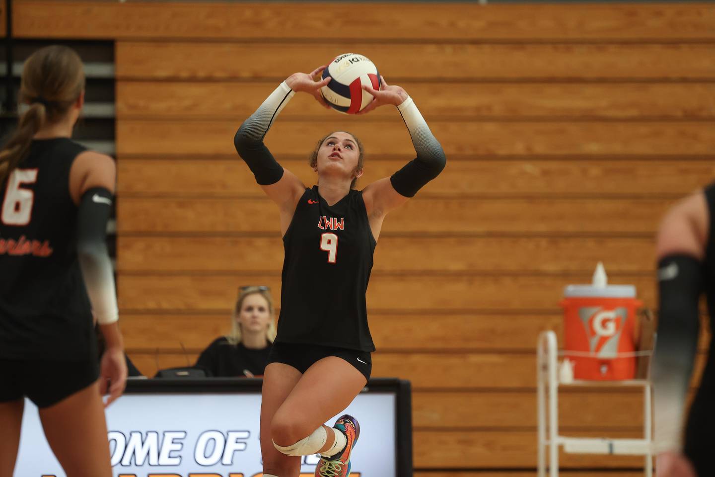 Lincoln-Way West’s Kara Stigter sets the ball against St. Laurence on Monday, August 26, 2024 in New Lenox.