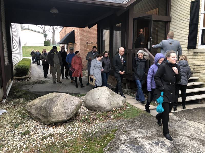 Dignitaries, including U.S. Rep. Bill Foster, file back into the Old Feed Mill following a ceremonial groundbreaking at the future Taylor Street Apartments in McHenry. The mill and adjacent brick building will be repurposed, with other buildings being torn down.