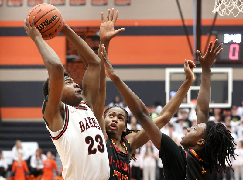 DeKalb’s Davon Grant goes to the basket against two Jefferson defenders Wednesday, Feb. 21, 2024, during their Class 4A regional semifinal game at DeKalb High School.