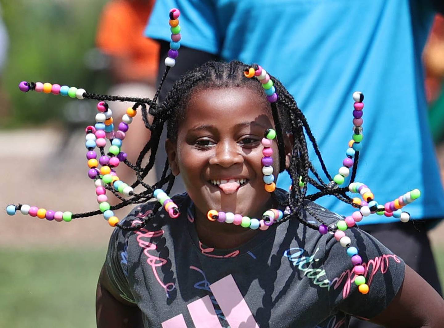 Malania Sanders, 6, from DeKalb, enjoys the sack race during Camp Power at Welsh Park in DeKalb. Camp Power, which is run by the Kishwaukee Valley YMCA, is a summer program for youth at University Village that provides positive activities for kids.