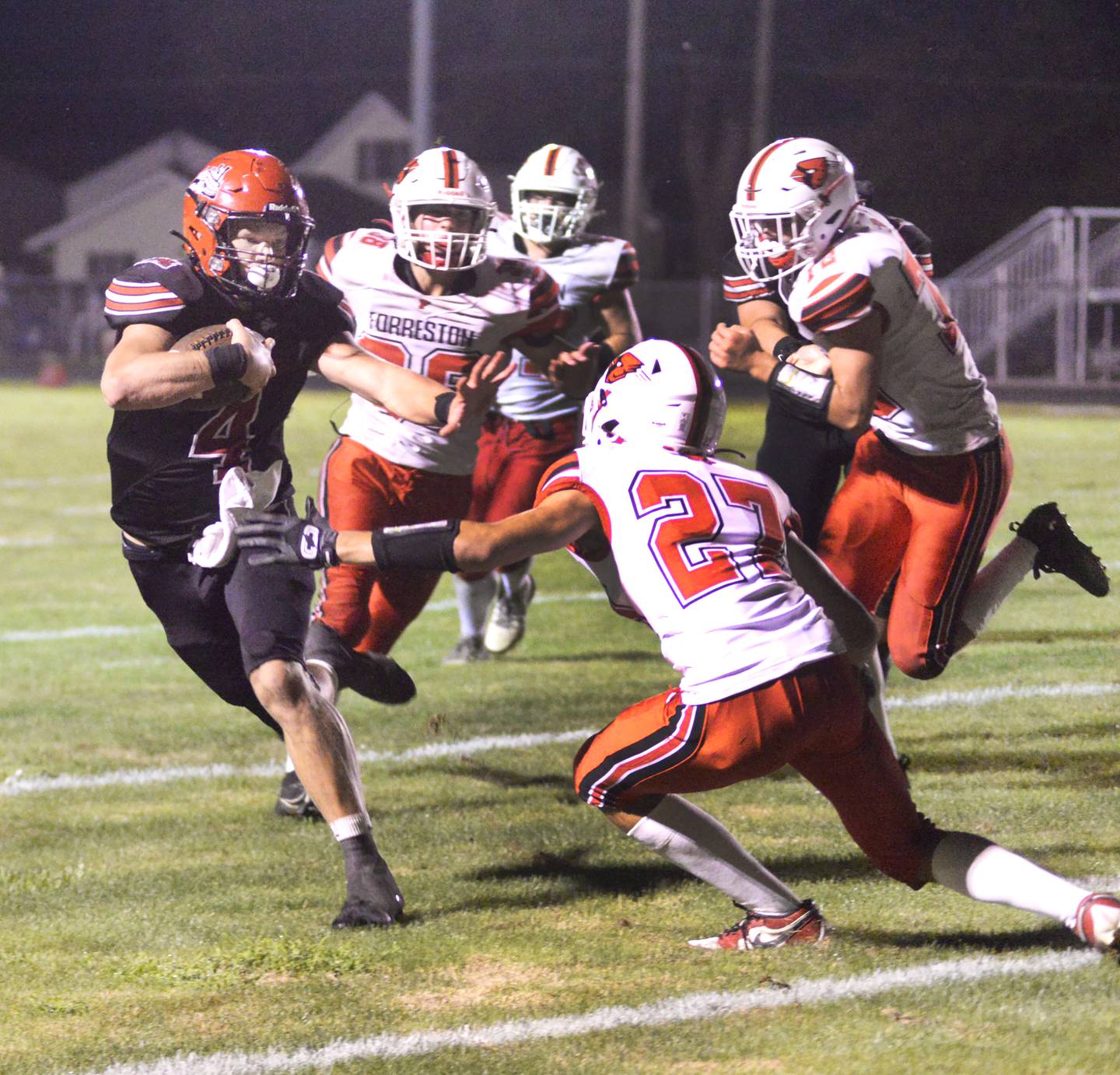 Fulton quarterback Dom Kramer fights off Forreston defenders during Friday, Aug. 30, 2024 action at Fulton High School. The Steamers won the game 28-0.