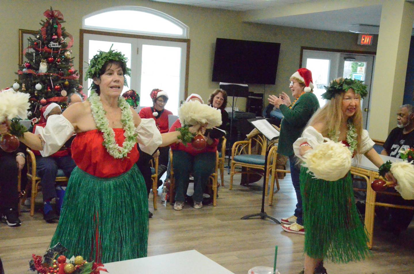 Pat Olek of Aurora and Rosemary Mikol, Chicago, perform hulas to "Silent Night," "Santa Claus is Coming to Town" and "Little Grass Shack." They danced during Oswego Senior Singers' concert at Wedgewood Manor in Montgomery on Friday, Dec. 16.