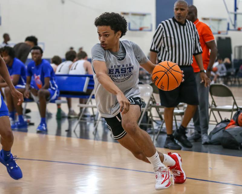 Oswego East's Michael Rembert (13) drives baseline at the Riverside-Brookfield Summer Shootout basketball tournament. June 22, 2024.