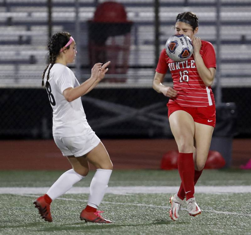 Huntley’s Nikki Brzezowski (right) stops the ball in front of McHenry's Elena Carlosn a Fox Valley Conference soccer match Thursday, April 13, 2023, at Huntley High School.