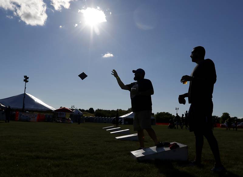 Chris Morrison and Steve Chvatal toss bags as they warm up for the Algonquin Founders’ Days Festival Bags Tournament Friday, July 29, 2022, at Ted Spella Community Park, 2610 Harnish Drive, in Algonquin. This year marks the festival’s 60th anniversary that includes over 40 events, including live music, food and drinks, a carnival, and market bazaar. The festival runs from 2 to 11 p.m. July 30 and 10 a.m. to 9 p.m. July 31. A Founders’ Day Christmas in July Parade will run through Main Street in downtown Algonquin beginning at 11 a.m. July 30.