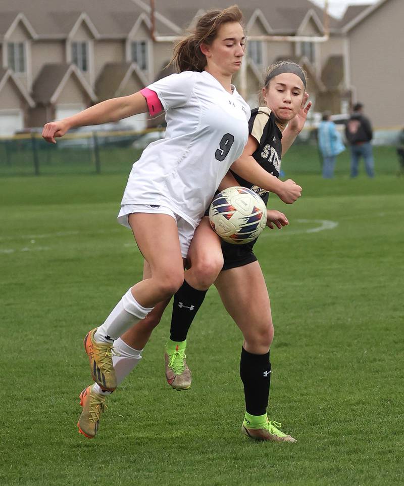 Kaneland's Jade Schrader (right) and Sycamore's Faith Schroeder try to win the ball during their game Wednesday, April 17, 2024, at Sycamore High School.