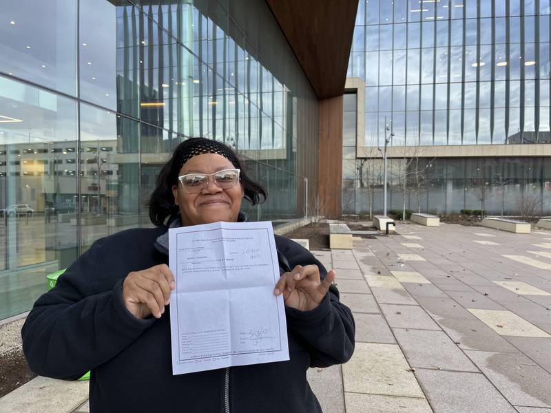 Konika Morrow, of Joliet, holding up Will County Judge Jessica Colón-Sayre's court order on Tuesday after she won her case on a charge of obstructing an officer.