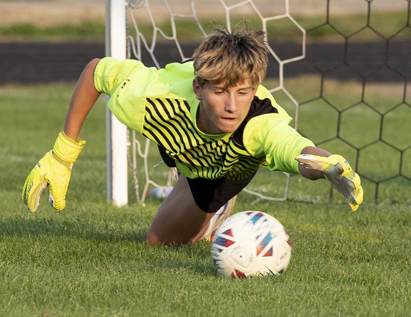 Oregon goalie Derek Withers dives to stop a shot against Dixon Wednesday, Sept. 11, 2024, at EC Bowers field in Dixon.