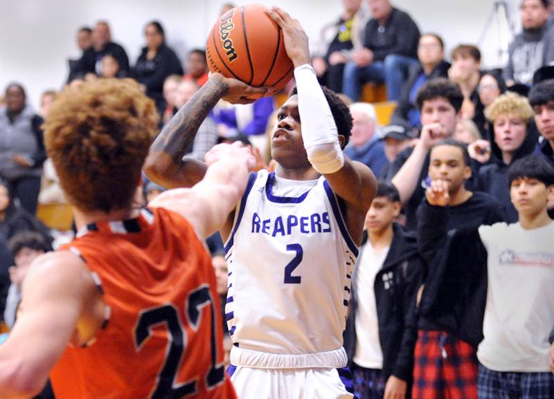 Plano's Alijah Johnson (2) takes a shot against Sandwich defender Dom Rome (22) during a varsity basketball game at Plano High School on Tuesday, Dec. 5, 2023.