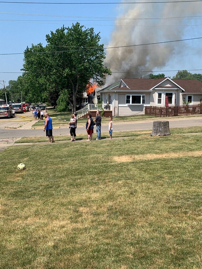 Residents watch as smoke and flames could be seen from a block away of a fire on the 100 block of East Caroline Street in Spring Valley.